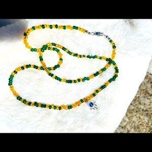 Glass bead thighlet with evil eye charm.
